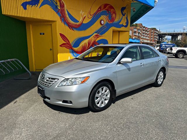 Silver saloon parked on a Cotonou street